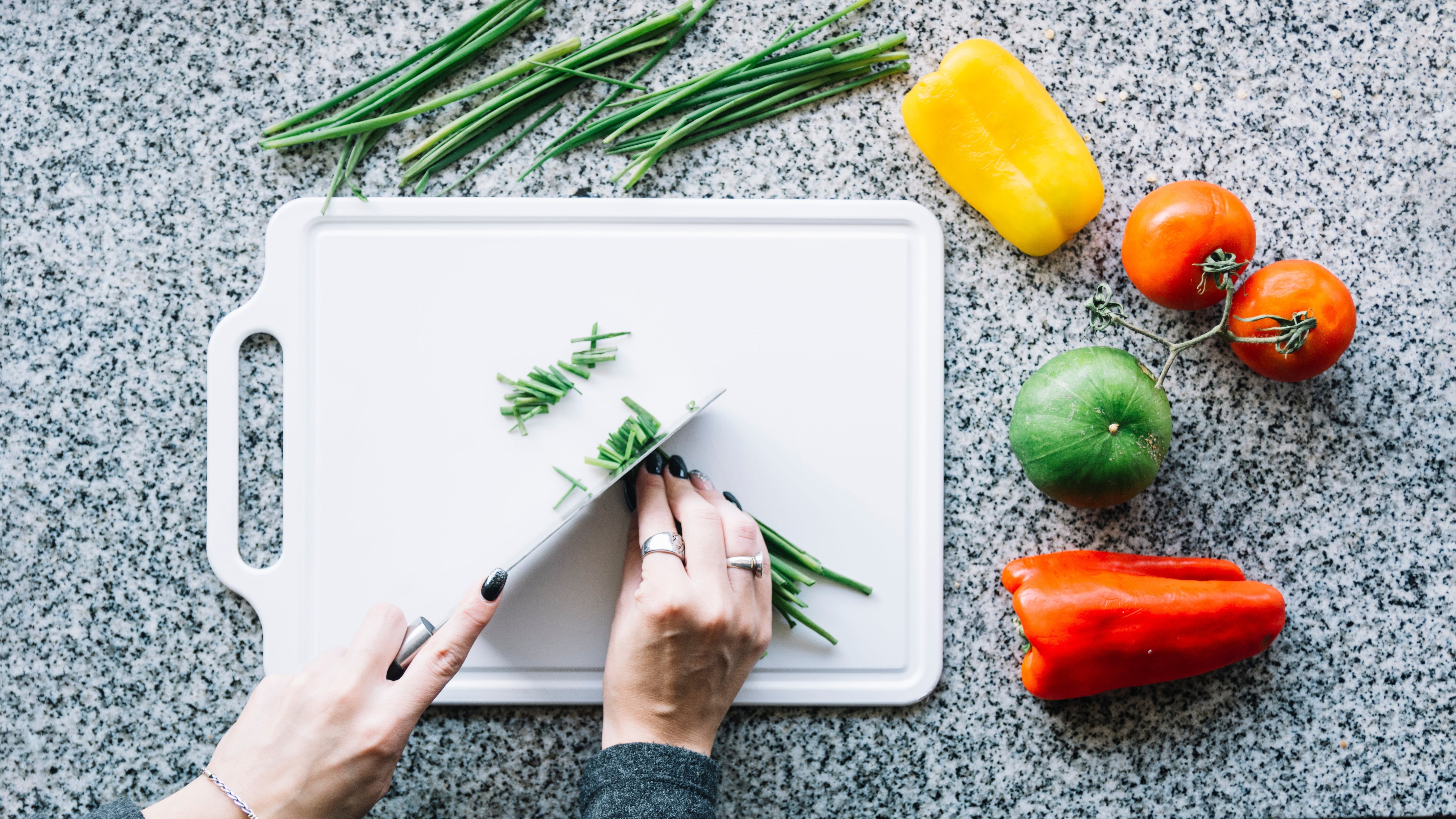 Chopping vegetables on a plastic cutting board—learn if this surface is the safest cutting board material for everyday use.