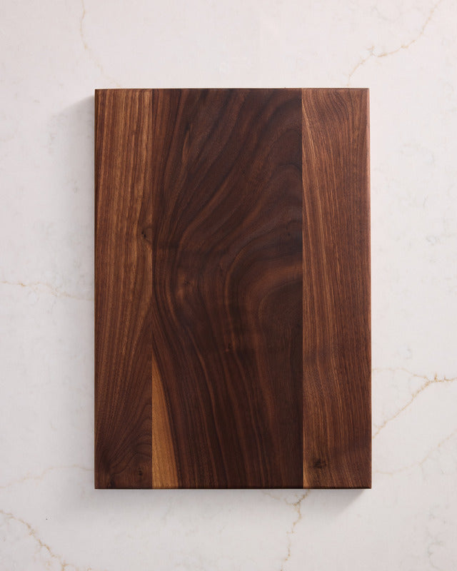 Medium rectangular walnut cutting board with rich grain finish, best wooden chopping board made from safest cutting board material.