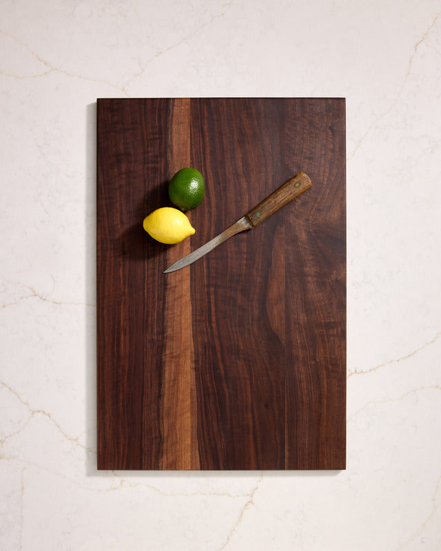 Thin walnut cutting board placed on kitchen counter, sleek wooden design and best non toxic cutting board for everyday use.