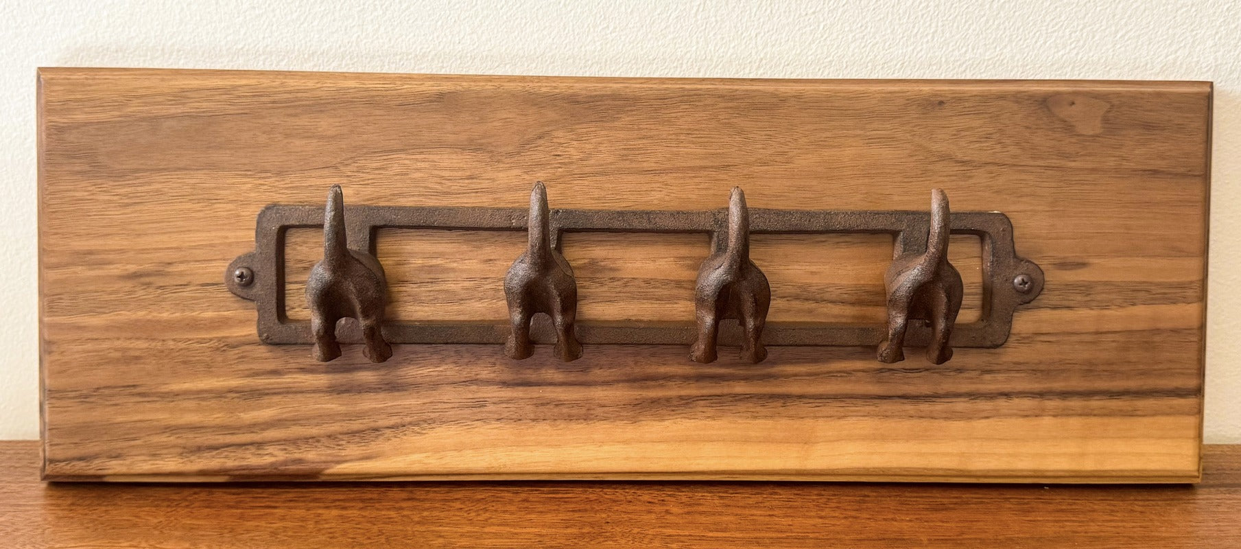 Custom walnut wood wall rack with four cast iron hooks — unique handcrafted wood décor and practical home gift.