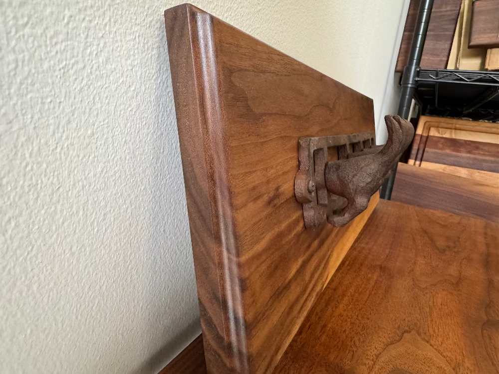 Close-up image of walnut wood wall hook handcrafted by Refined Surroundings, showcasing fine woodworking and natural tone.