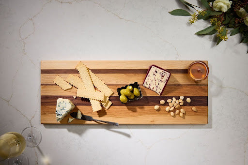 Best wooden chopping board used as personalized charcuterie board serving tray with handles for elegant hostess gift idea.