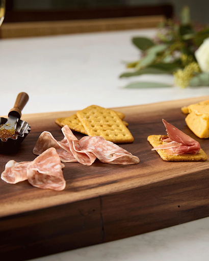 Walnut cutting board styled as personalized charcuterie board, safest cutting board material for cheese tray and meats.