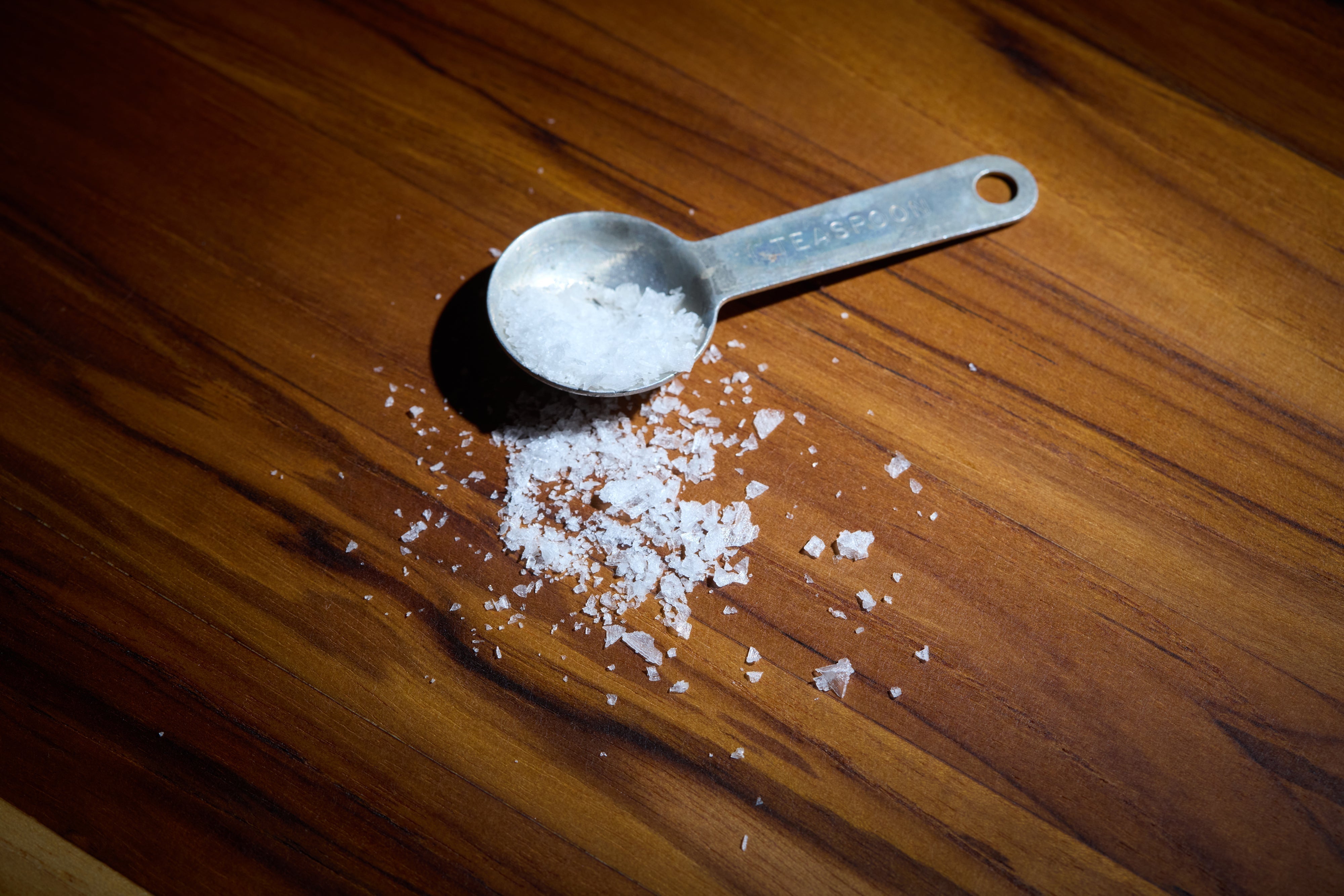 Close-up of a walnut cutting board by Refined Surroundings, showcasing handcrafted grain detail, luxury design, and food-safe hardwood craftsmanship.