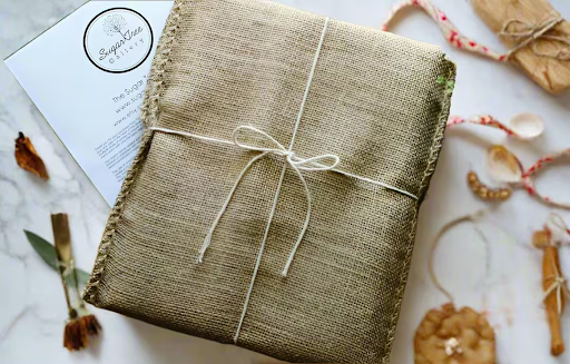 Personalized charcuterie board wrapped in fabric cloth for gifting; perfect hostess gift or custom board decor idea