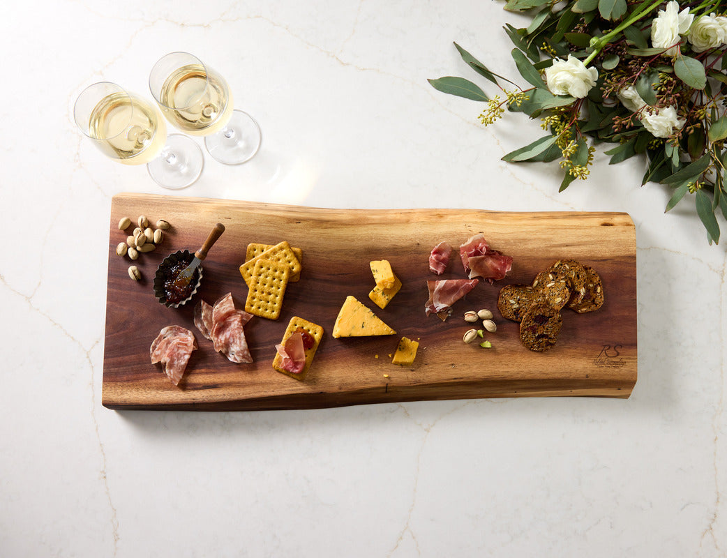 Live edge charcuterie cutting board styled with crackers, nuts and cheese, the best non toxic and healthiest cutting board.
