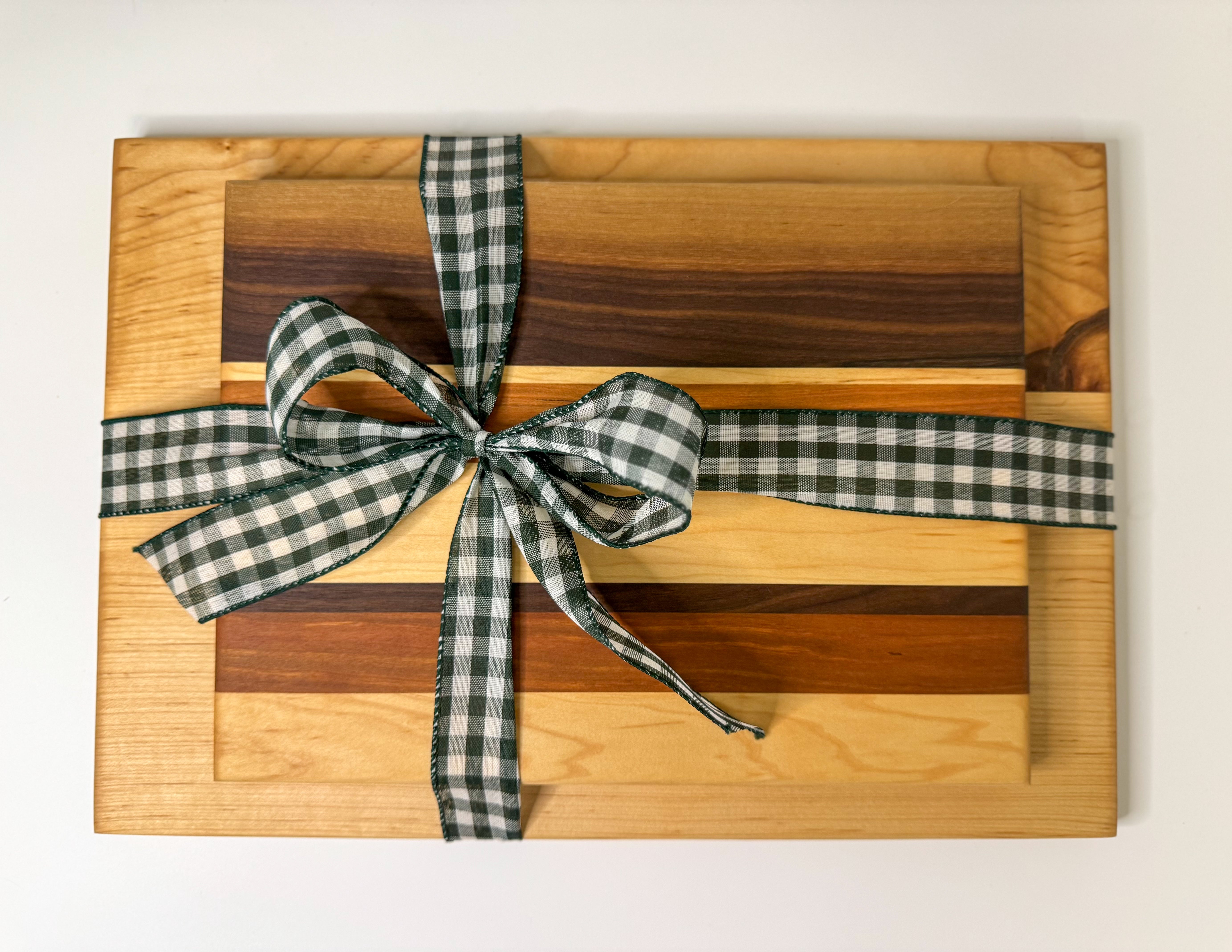 Maple and walnut custom wood cutting boards tied with ribbon, healthiest cutting boards and unique gift design.
