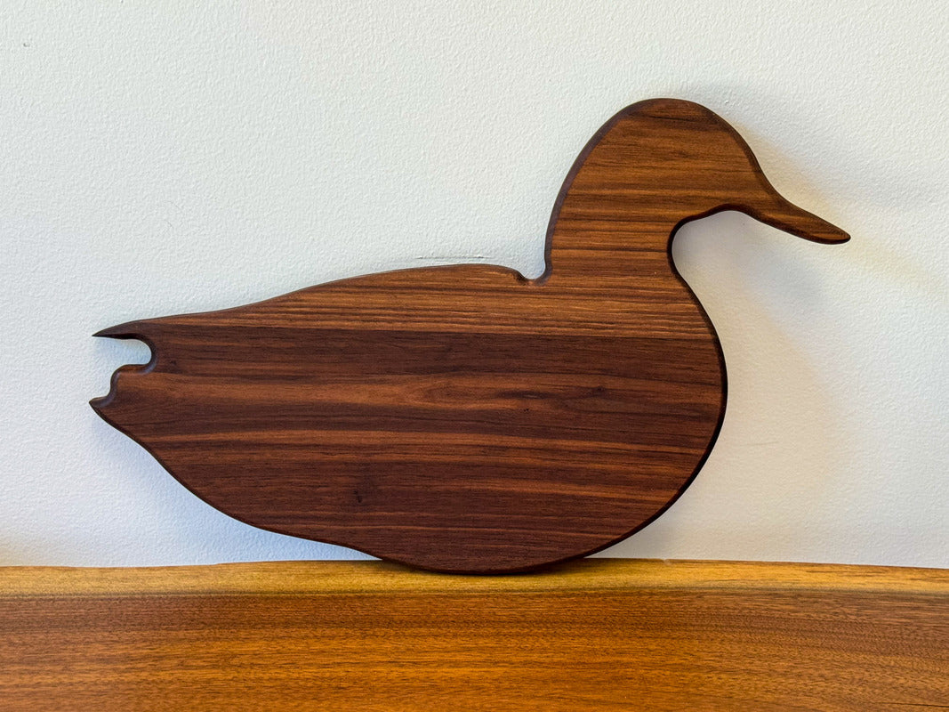 Handcrafted walnut cutting board with rich grain — ideal as a custom charcuterie board or stylish wooden serving tray.