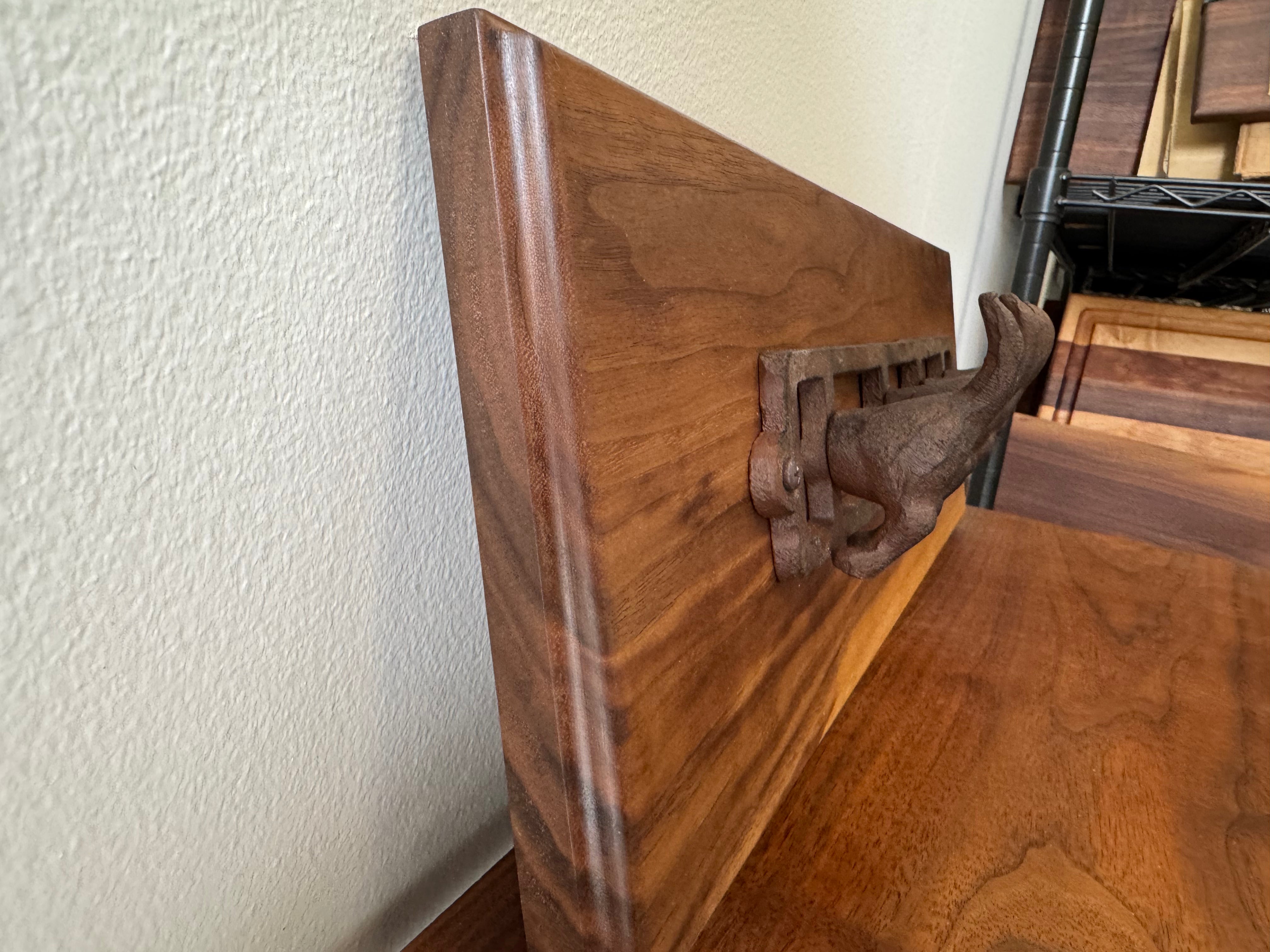 Close-up image of walnut wood wall hook handcrafted by Refined Surroundings, showcasing fine woodworking and natural tone.